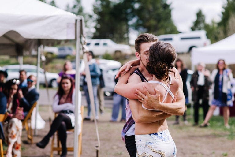 Wedding couple preforming aa AcroYogo routine as their first dance in McCall, Idaho.