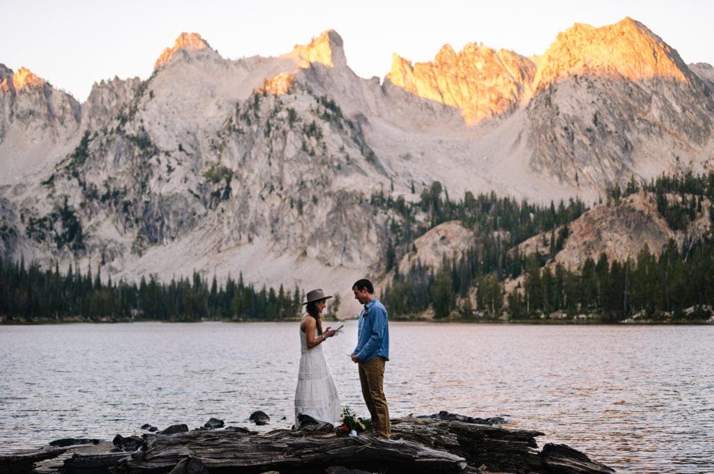 Couple exchanges vows at sunrise during their elopement ceremony in Stanley, Idaho.