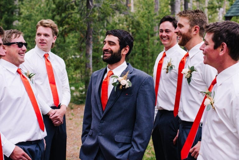 Groomsmen and groom laughing during a Redfish Lake Lodge Wedding in Stanley, Idaho.