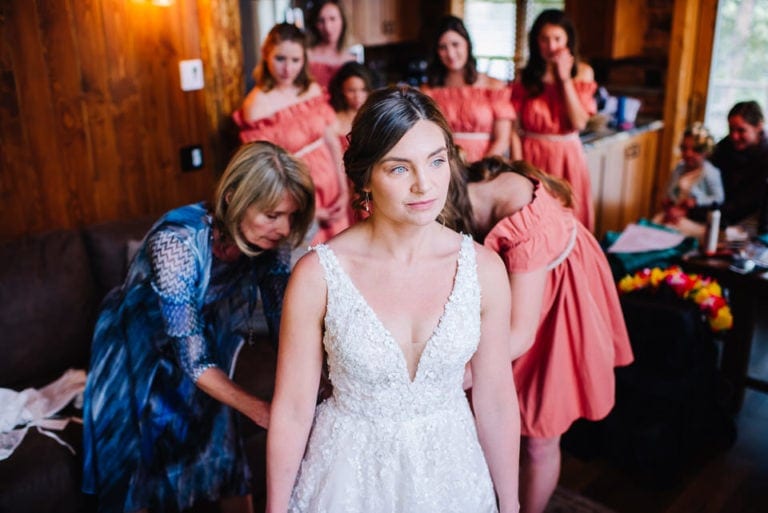 Bridal party helps bride get ready during a Redfish Lake Lodge Wedding in Stanley, Idaho.