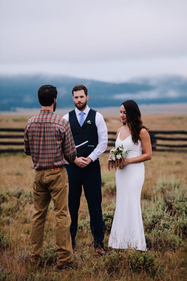 Couple elopes in the sawtooth mountains at sunrise with a cloudy background.
