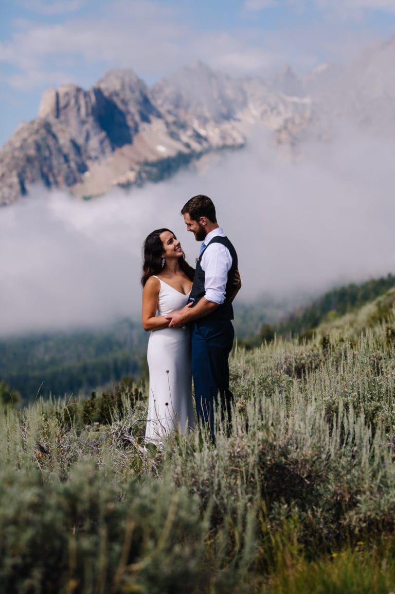 Elopement couple stands together in the clouds after their sawtooth mountain elopement.