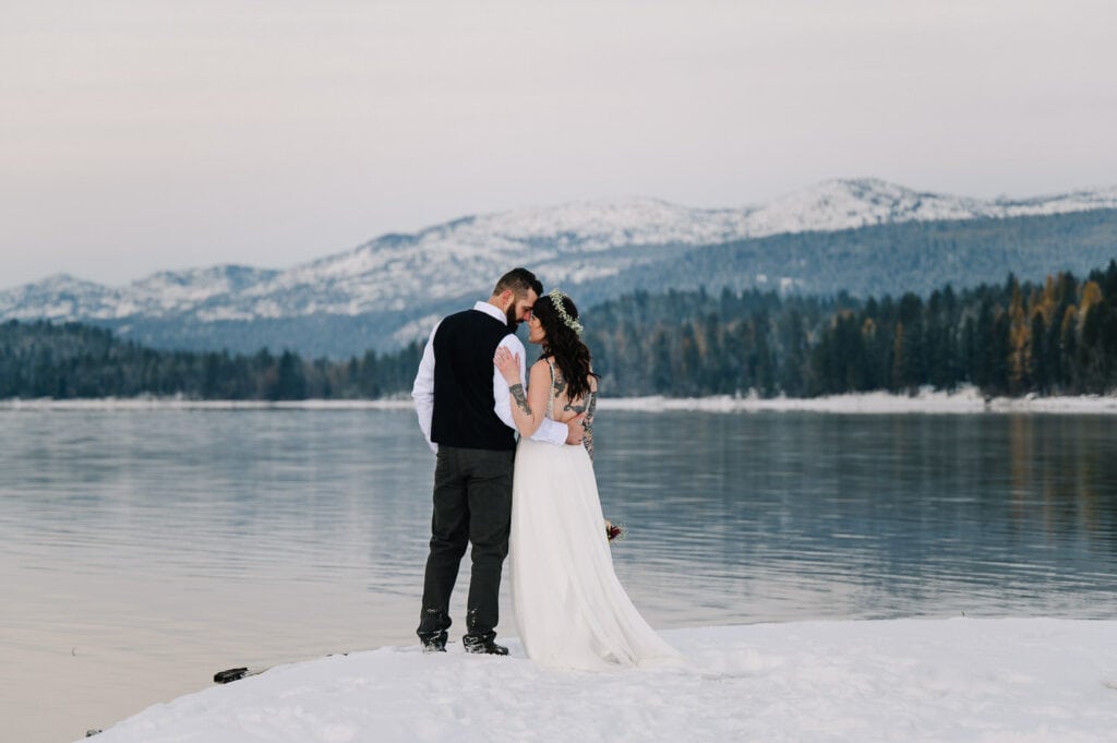 A bride and groom stand together after their elopement ceremony in Ponderosa State Park in McCall, Idaho.