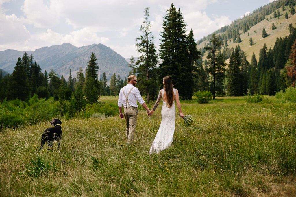 A couple walks through a mountain meadow during their elopement in McCall, Idaho.