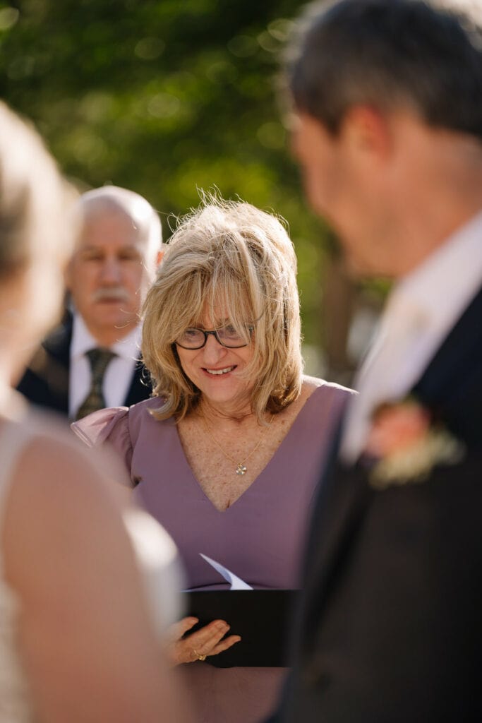 The mother of the bride reads a poem during an elopement ceremony.